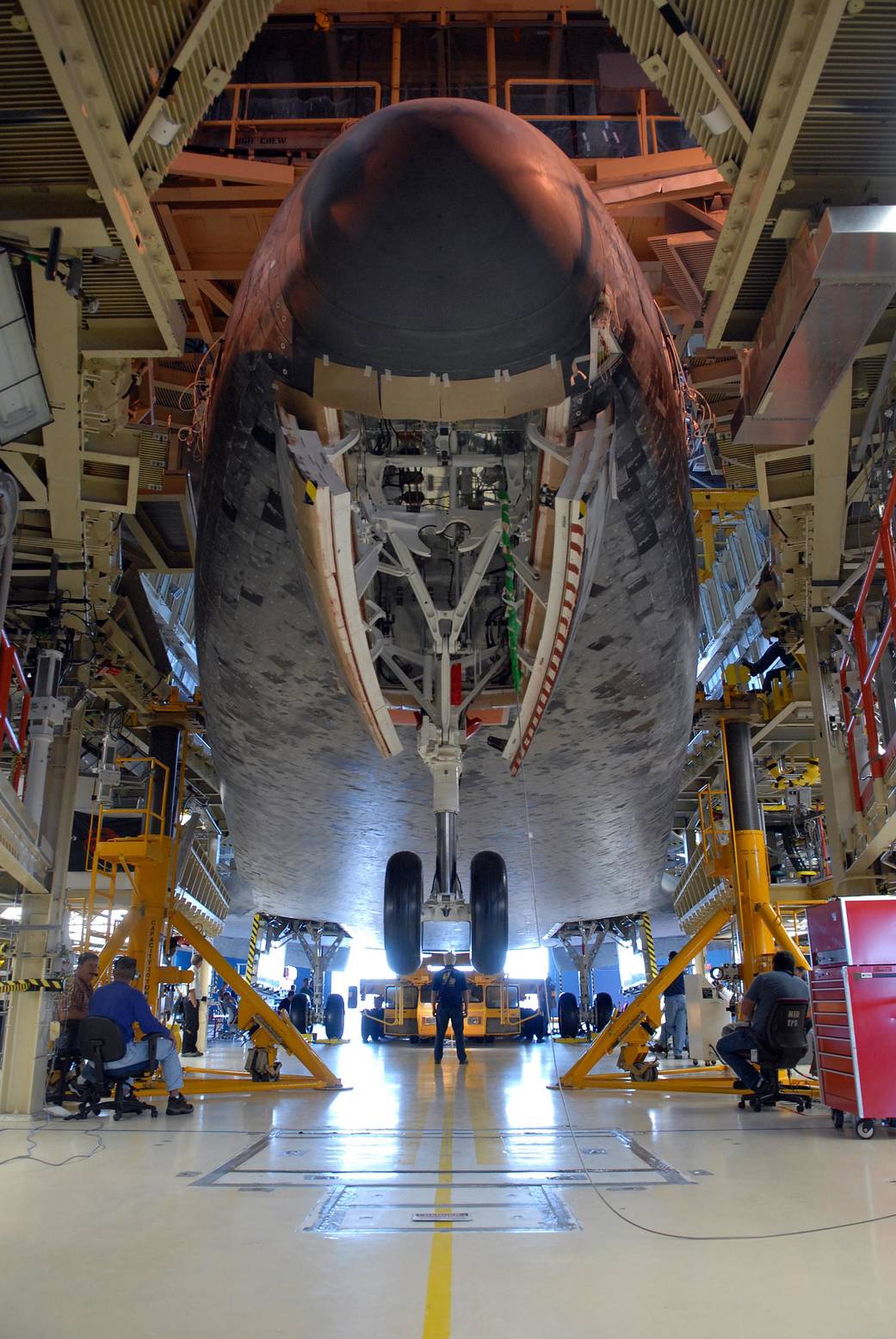 View from front center below nose of shuttle Discovery inside hangar at NASA Kennedy Space Center