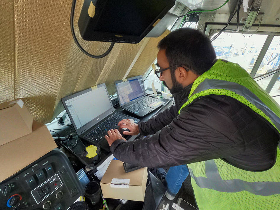 A researcher monitors testing equipment from inside the Mobile Laboratory.