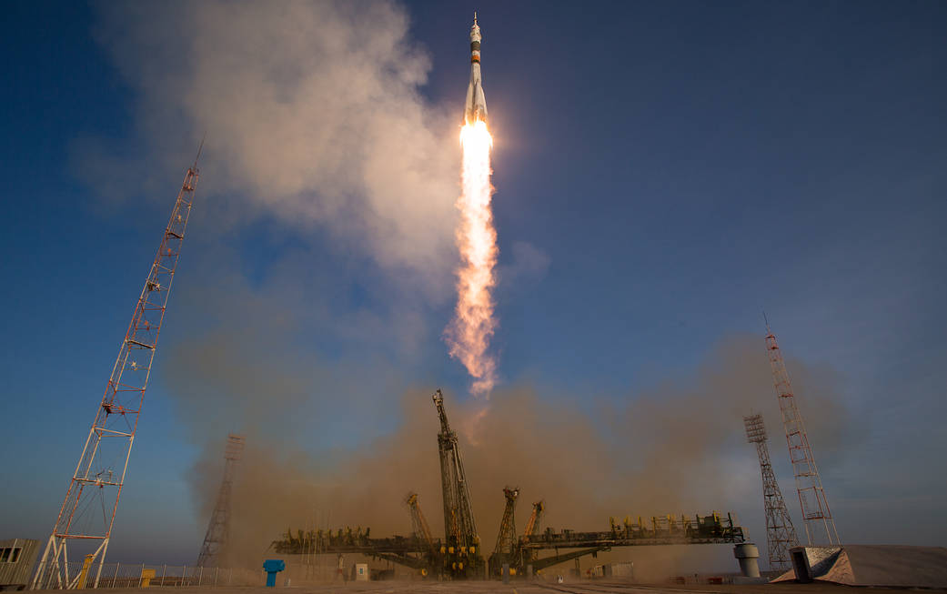 Liftoff of Soyuz rocket in daytime from launchpad at Baikonur Cosmodrome