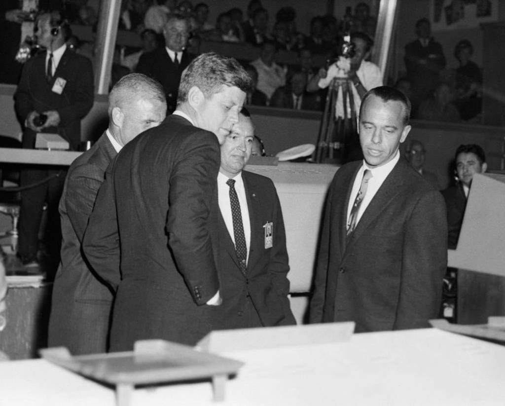 President Kennedy at mission control center with astronaut John Glenn and flight director Chris Kraft