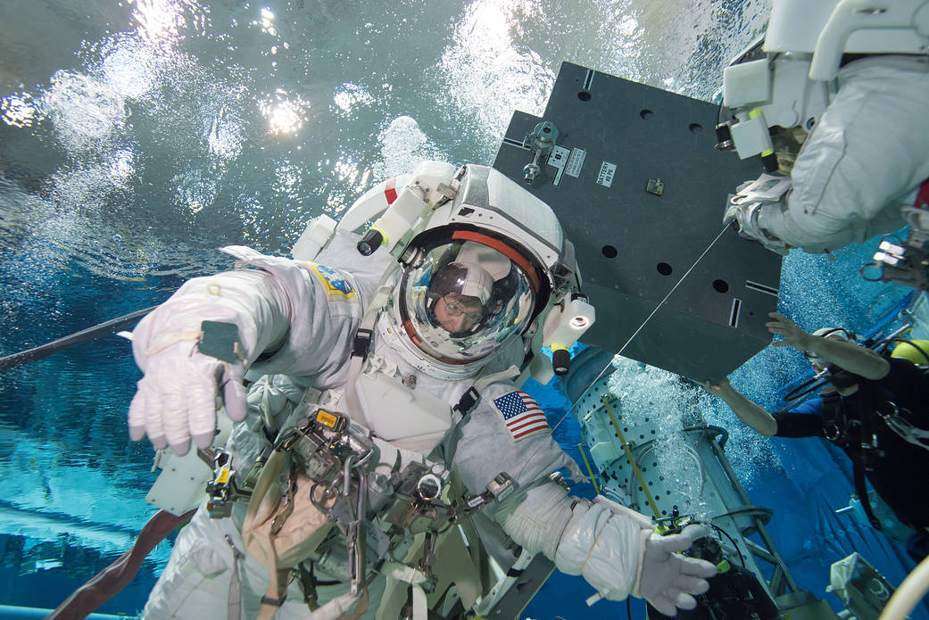 NASA astronaut Peggy Whitson in spacesuit during training underwater 