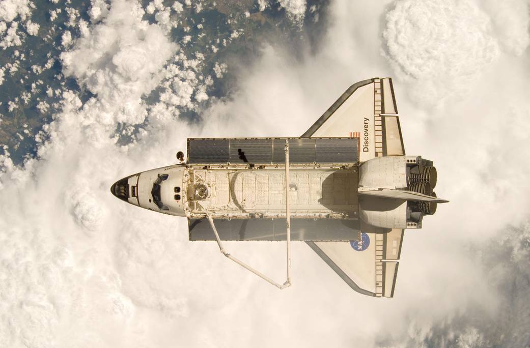 Shuttle Discovery imaged from above with Earth below