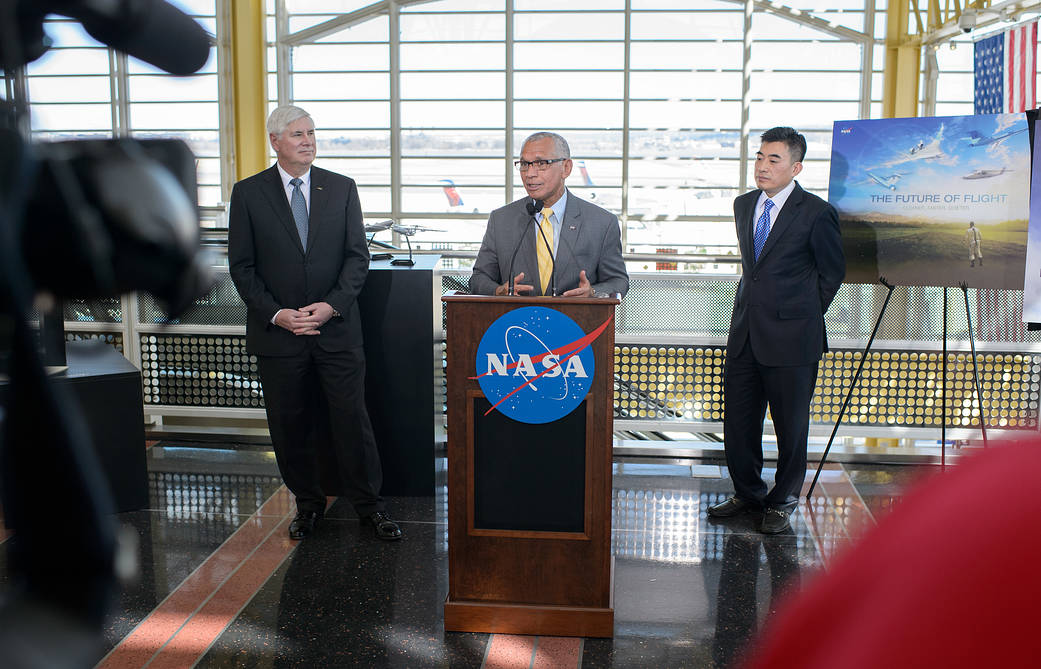 NASA Administrator Bolden at podium inside airport making announcement