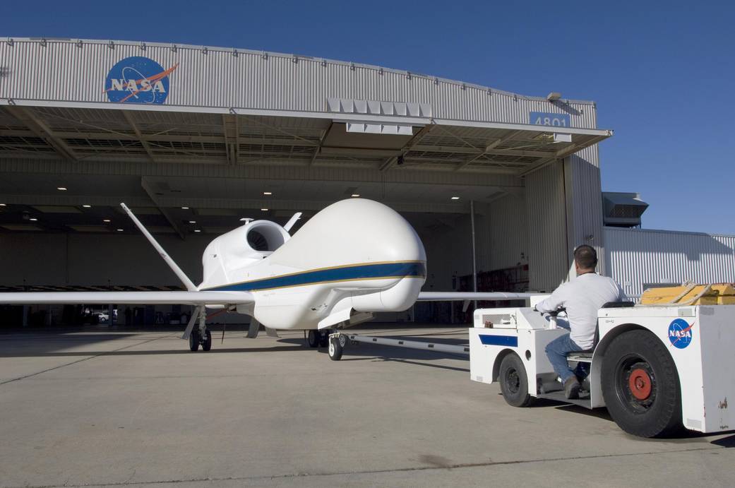 Ground Crew Maneuvers Global Hawk into Hangar