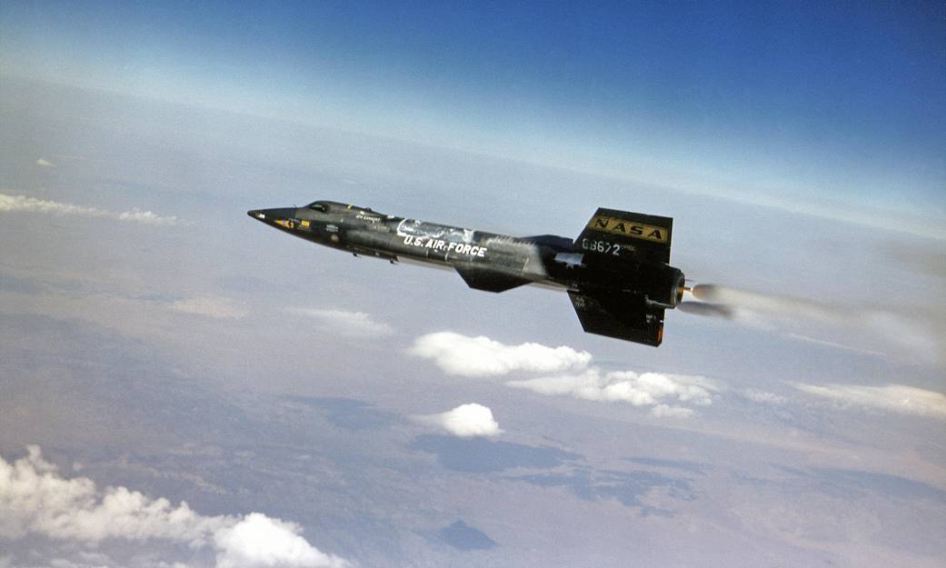During a preflight checkout of X-15 #3, a ground crewman writes in the frost covering its underside "250,000 OR NO ICE CREAM." M