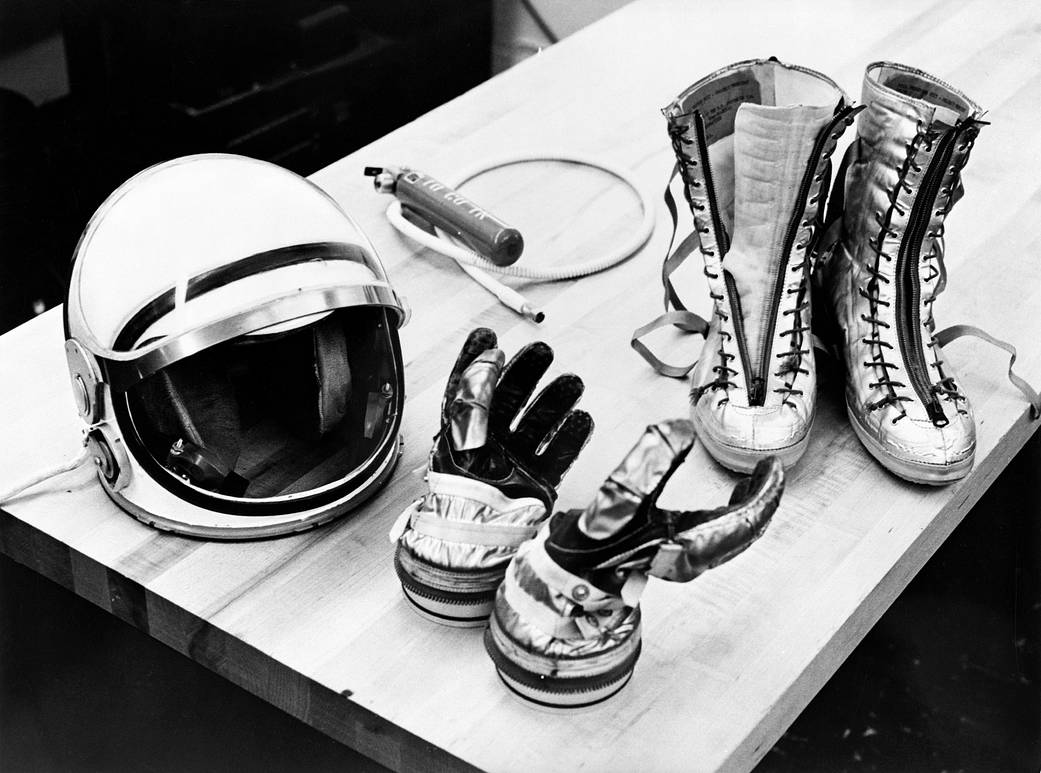 Helmet, astronaut gloves and boots from Mercury spacesuit on table