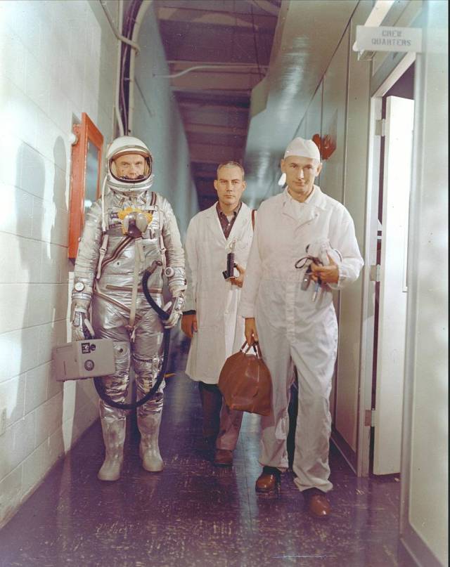 John Glenn walks with two others as her prepares for his Mercury-Atlas 6 mission