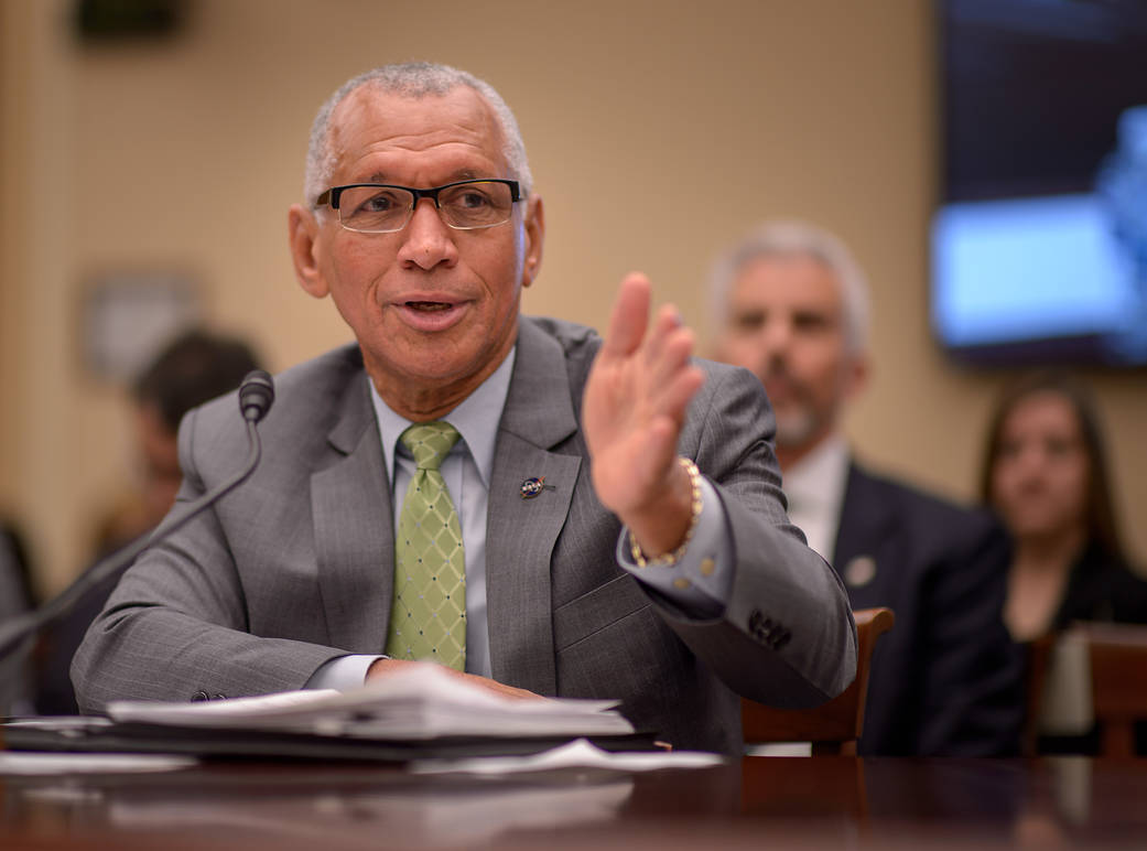 NASA Administrator Bolden speaks at conference table at House committee hearing