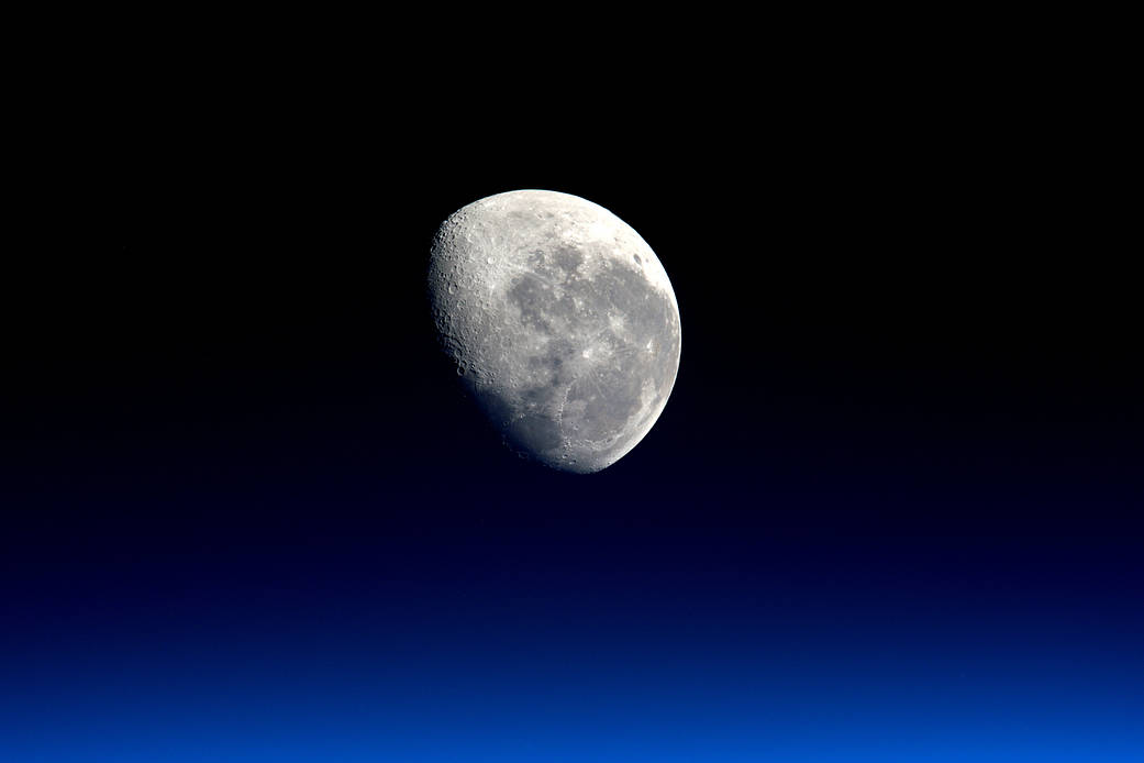 Earth's moon photographed from low Earth Orbit with blue at bottom of frame