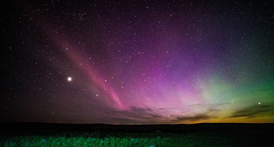 STEVE (Strong Thermal Emission Velocity Enhancement) is seen as a thin purple ribbon of light. Credit: ©Megan Hoffman