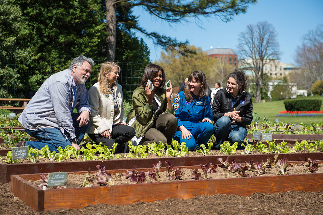 First Lady Michelle Obama and NASA officials plant seeds in garden