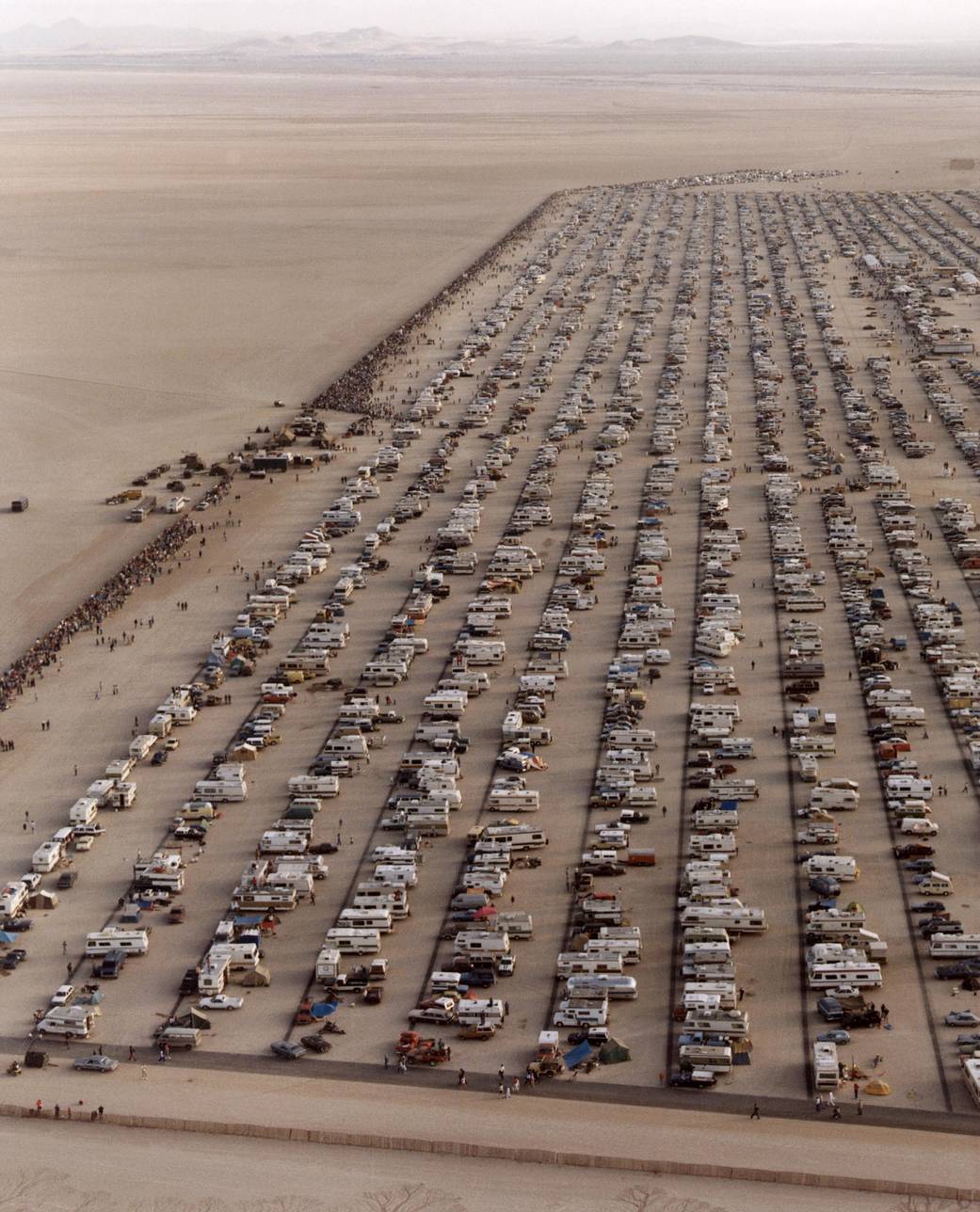 This aerial photo shows the large crowd of people and vehicles that assembled to watch the landing of STS-4 at Edwards Air Force