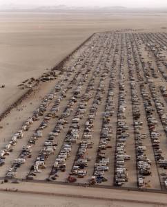 This aerial photo shows the large crowd of people and vehicles that assembled to watch the landing of STS-4 at Edwards Air Force