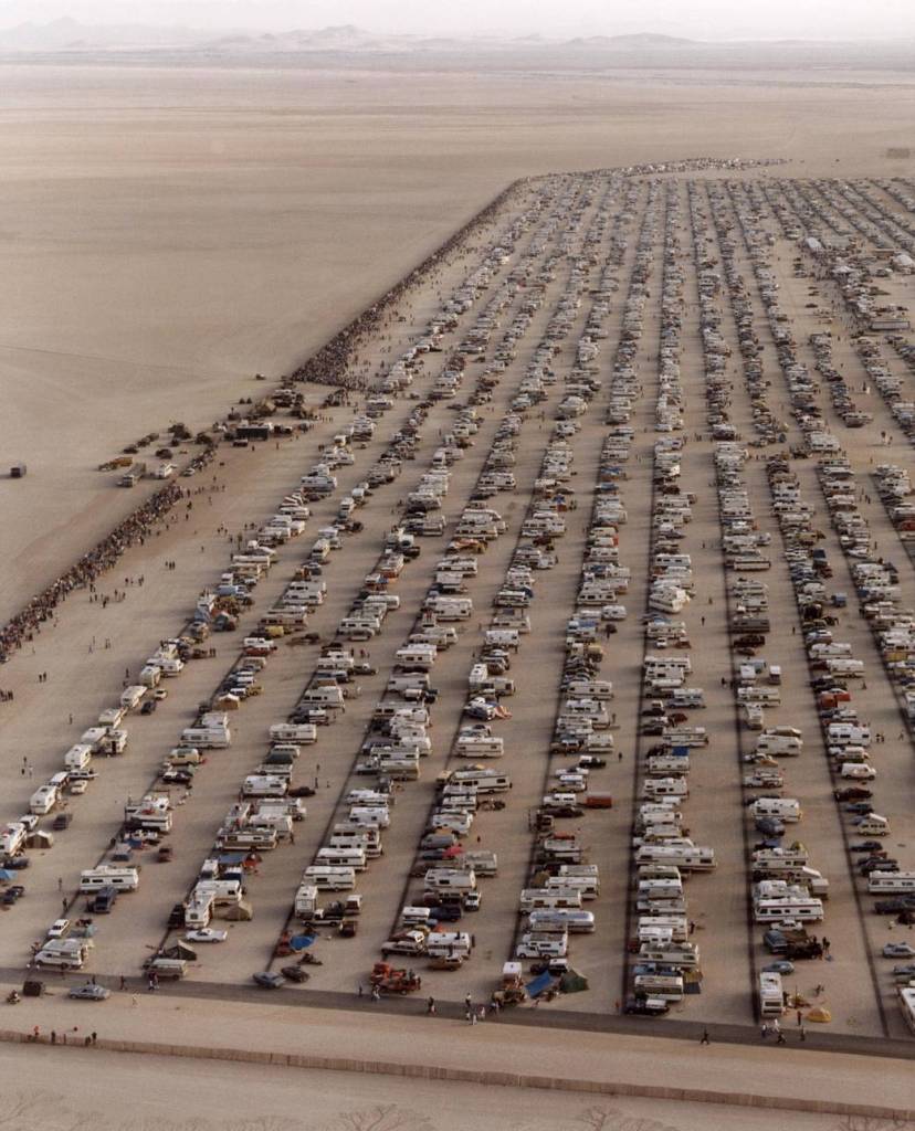 This aerial photo shows the large crowd of people and vehicles that assembled to watch the landing of STS-4 at Edwards Air Force