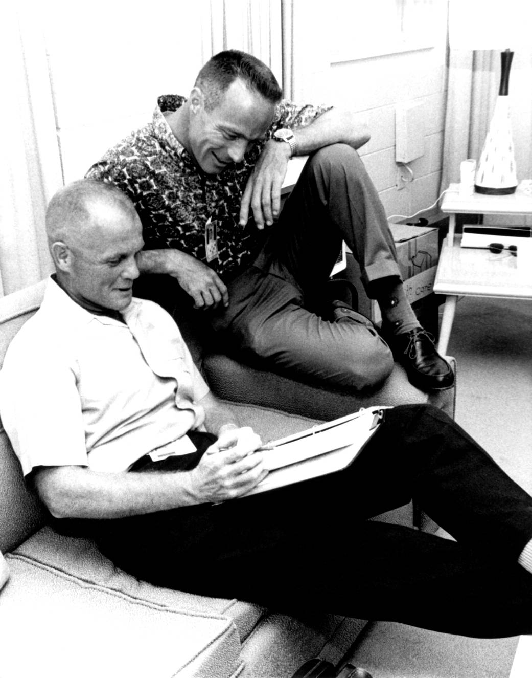 John Glenn prepares for MA-7 flight as Scott Carpenter looks on
