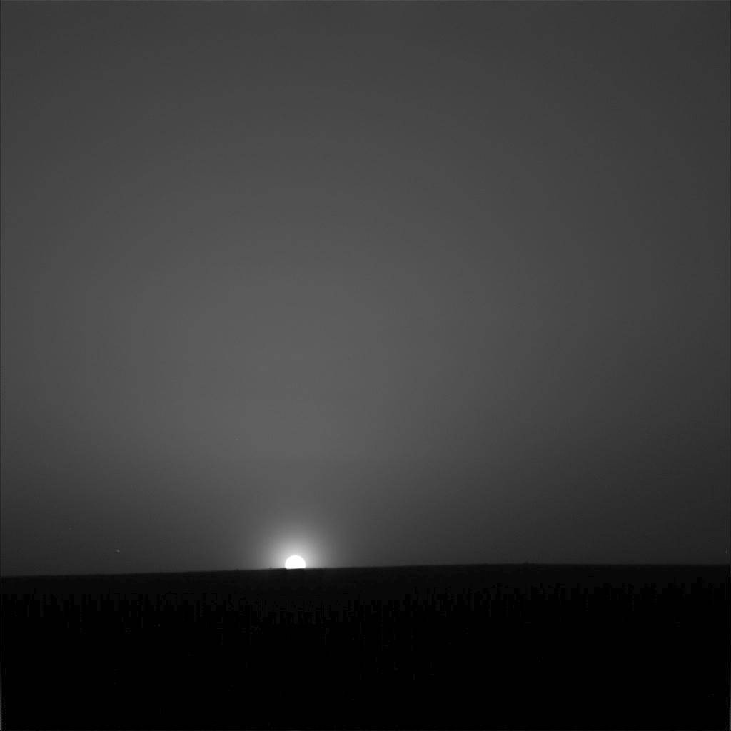 Sun just above distant horizon on Mars