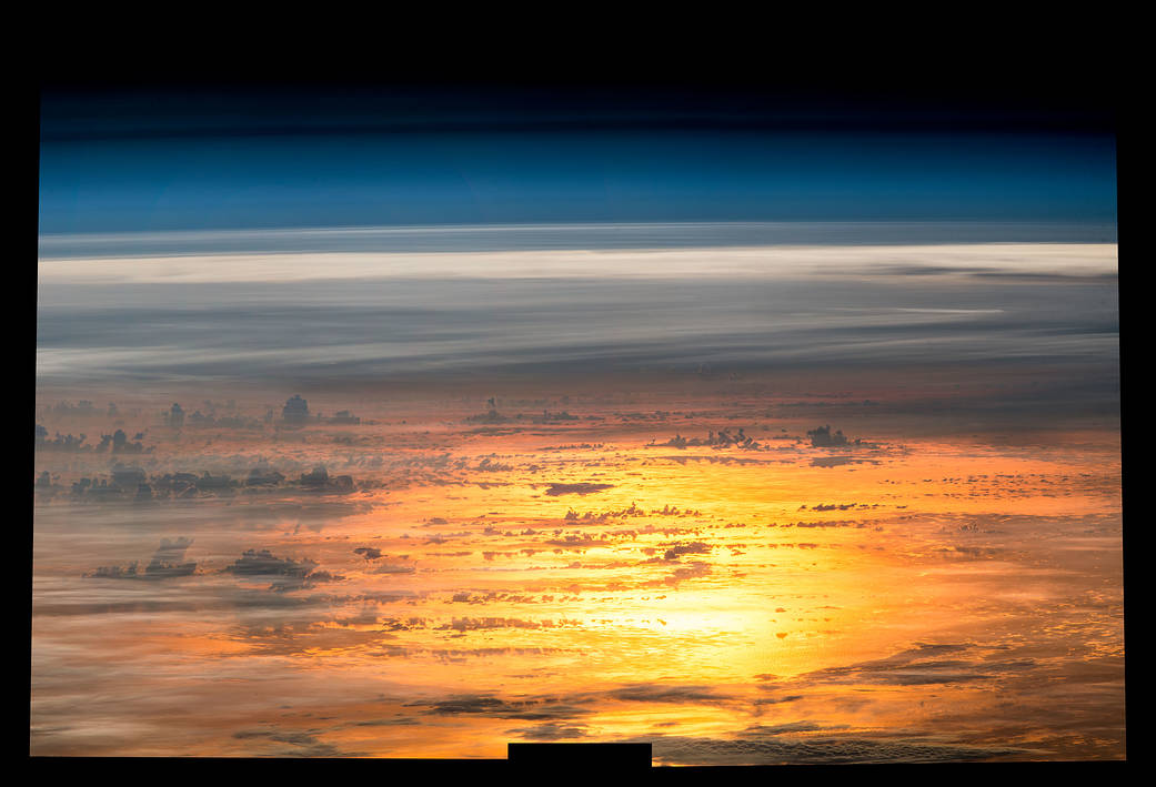 Composite image of brilliant sunset over water photographed from low Earth orbit