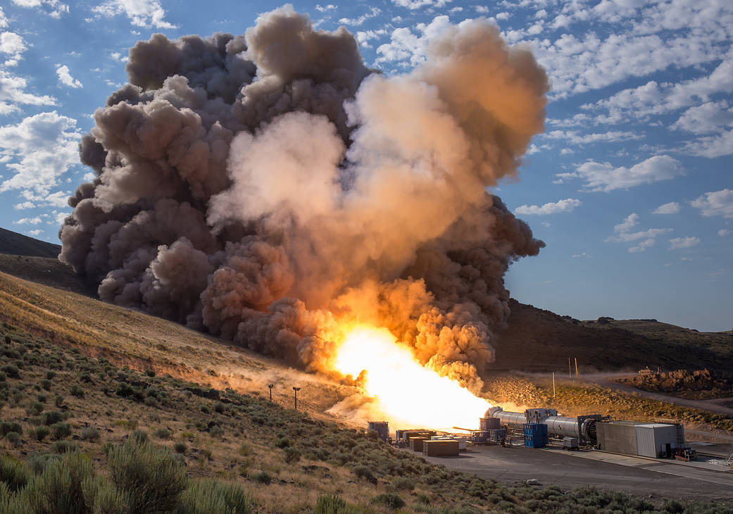 Rocket booster horizontal on ground fires up for test