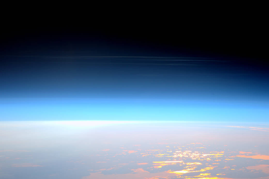 High altitude clouds photographed from orbit with Earth surface below