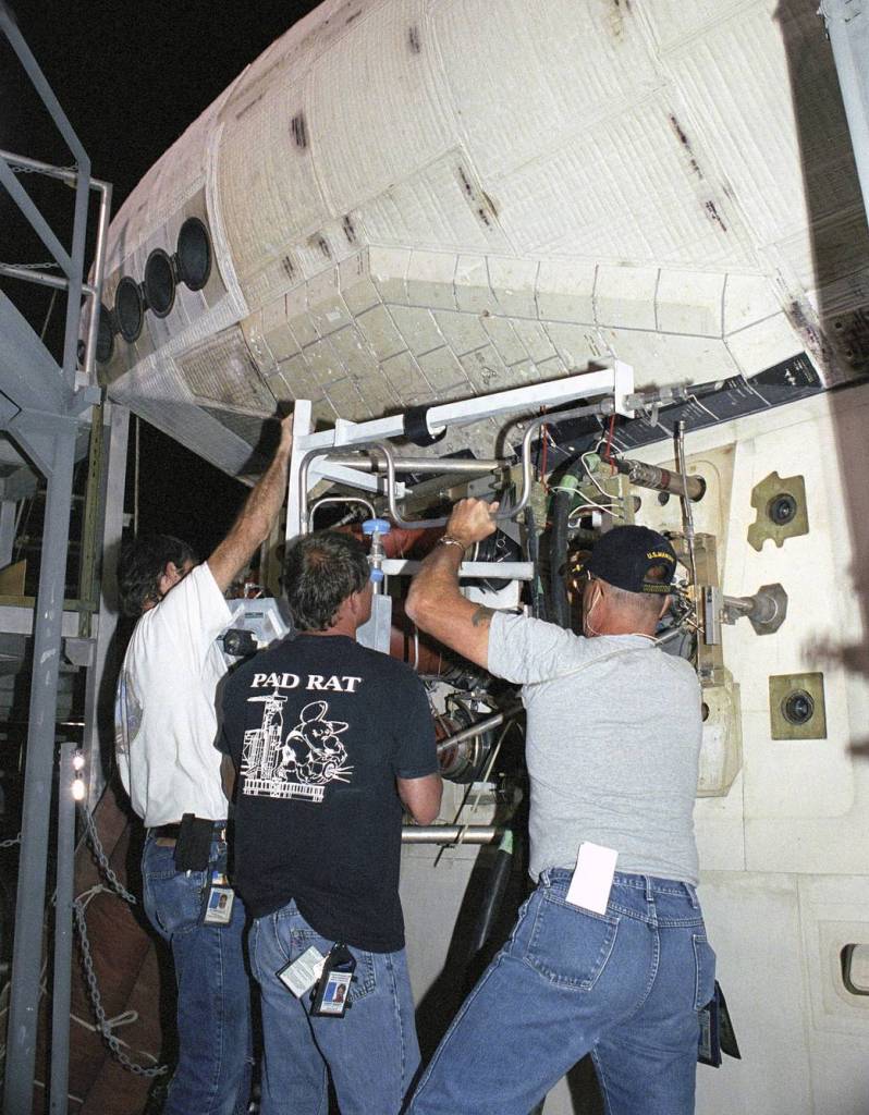 STS-114 Technicians Remove a Servicing Unit from the Space Shuttle Discovery