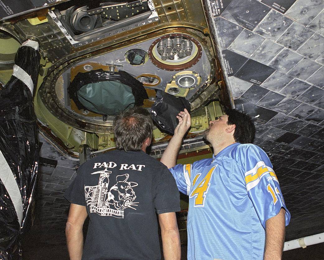 STS-114 Technicians Inspect External Tank Fittings on Shuttle Discovery