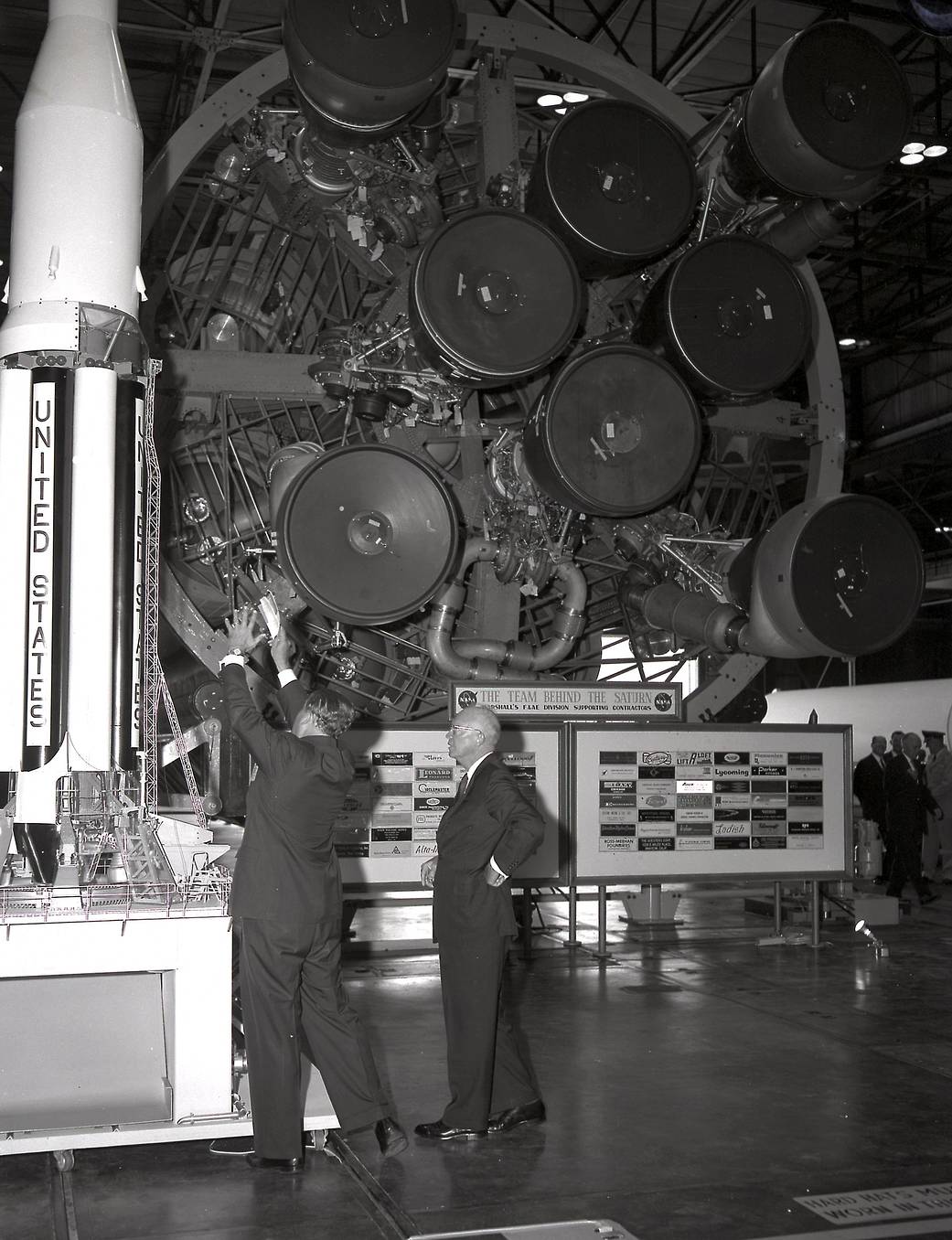 President Eisenhower and Wernher Von Braun looking at the end of a Saturn rocket