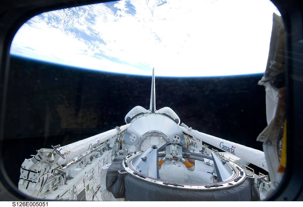 View from the opened bay of shuttle Endeavour with Earth horizon in background