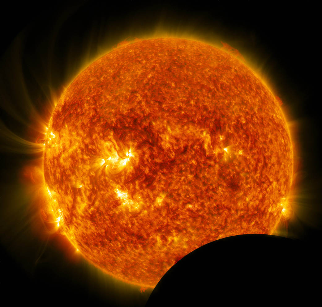This image shows the blended result of two SDO wavelengths during a lunar transit - one in 304 wavelength and another in 171 wav