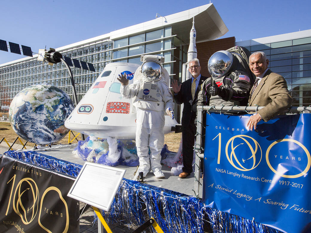 NASA Administrator Bolden and Langley Research Center Director Dr. Bowles on parade float with staff dressed in spacesuits
