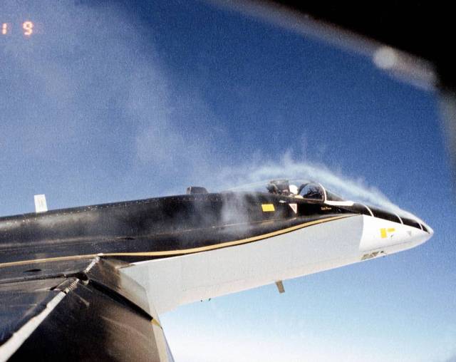 Smoke generators and yarn tufts are used for flow visualization studies on an F/A-18.