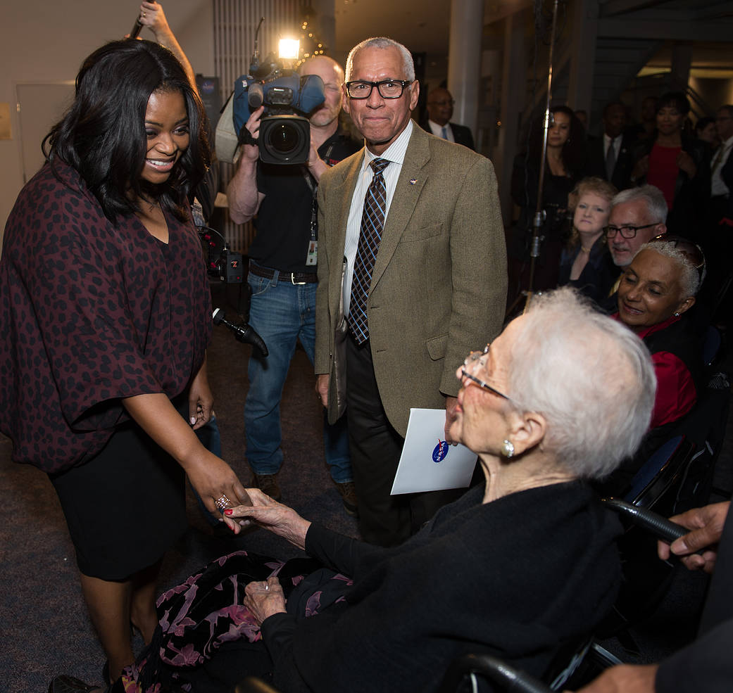 Actress Octavia Spencer greets Katherine Johnson as NASA Administrator Bolden stands nearby