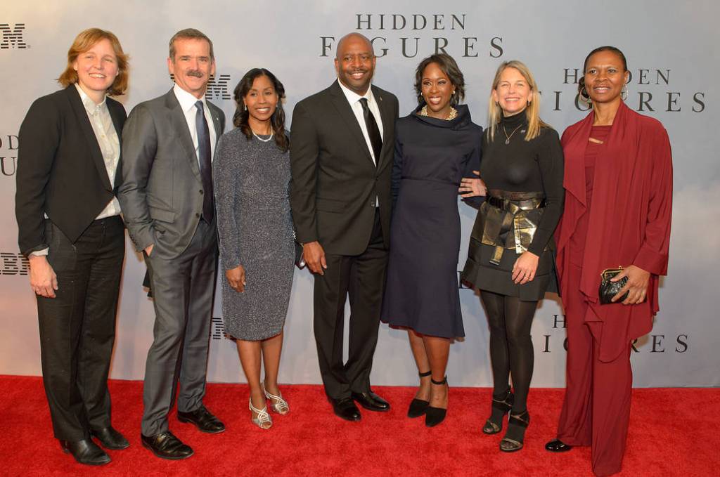 Seven people pose for red carpet photo at film premiere