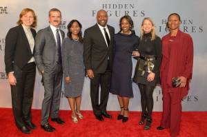 Seven people pose for red carpet photo at film premiere