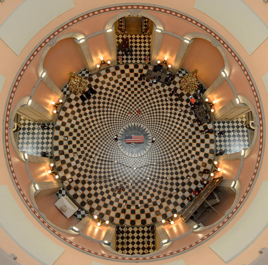Overhead view of rotunda at Ohio state house with flag draped coffin in center