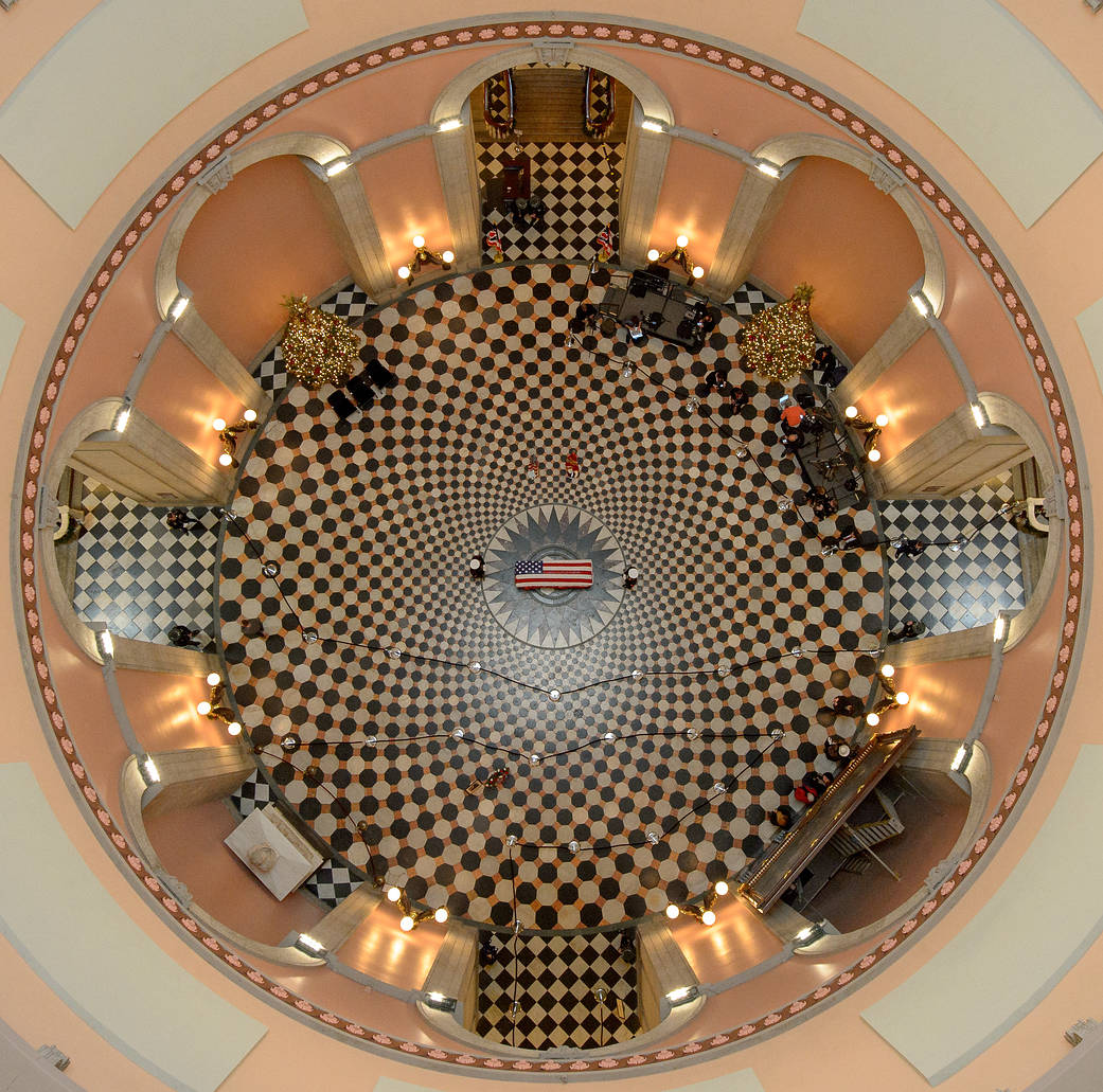 Overhead view of rotunda at Ohio state house with flag draped coffin in center