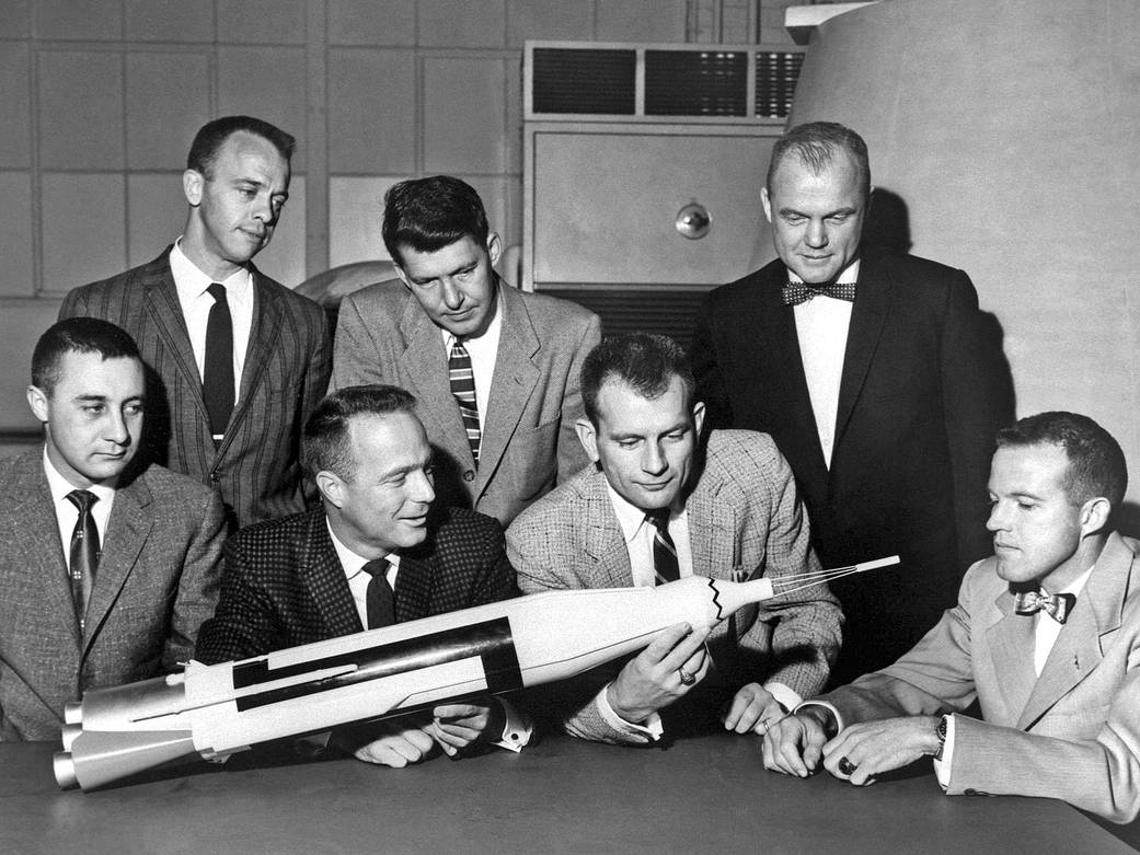 Original seven Mercury astronauts with model of rocket