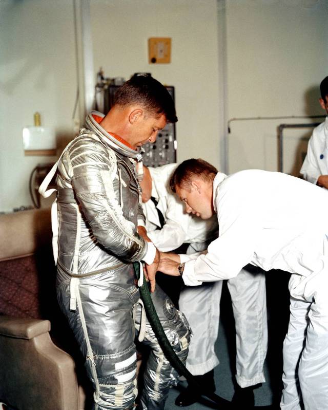 Astronaut Walter Schirra goes through a suiting-up exercise in Hangar S.