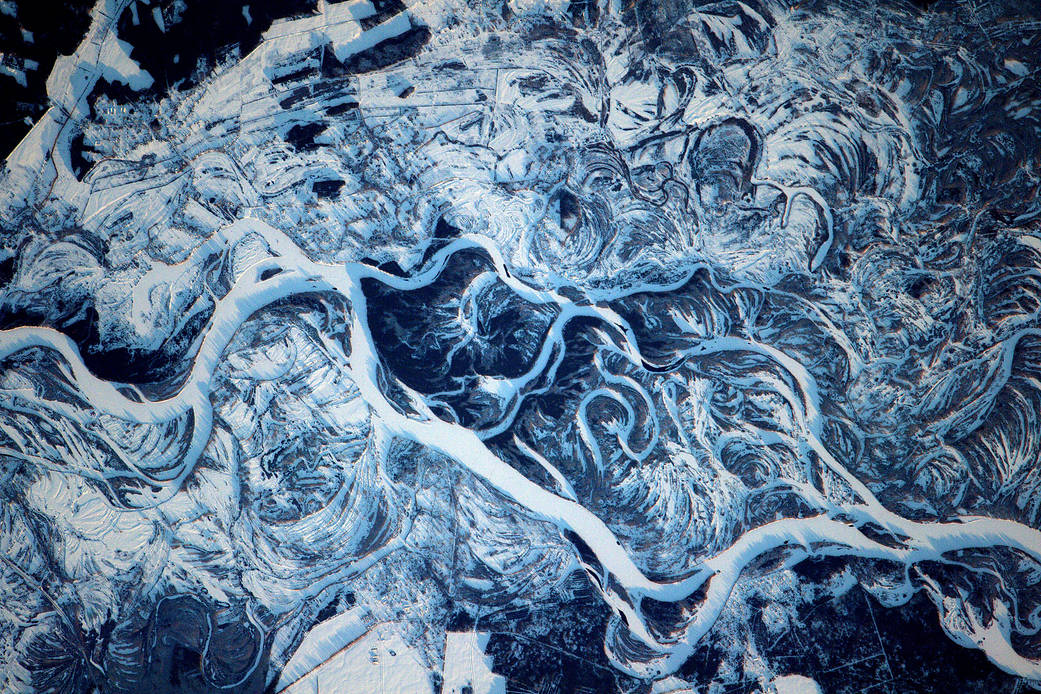 Curling frozen waterways sprawling across the Dnieper River 