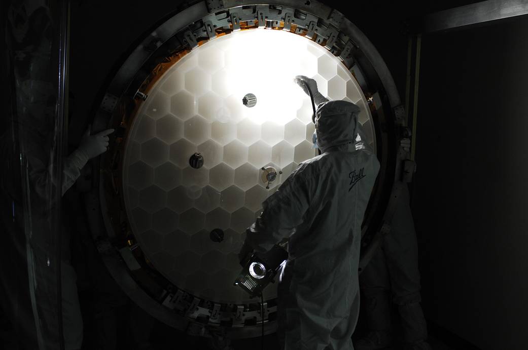 Honeycomb mirror examined by technician