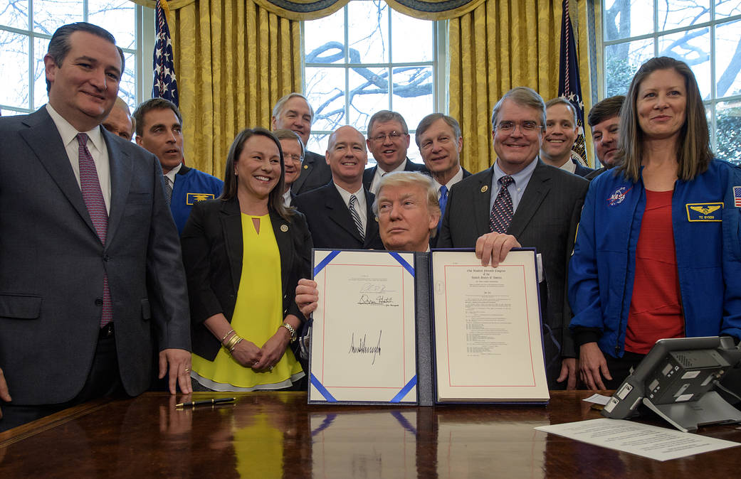 President Donald Trump holds signed NASA authorization act alongside NASA officials and members of Congress