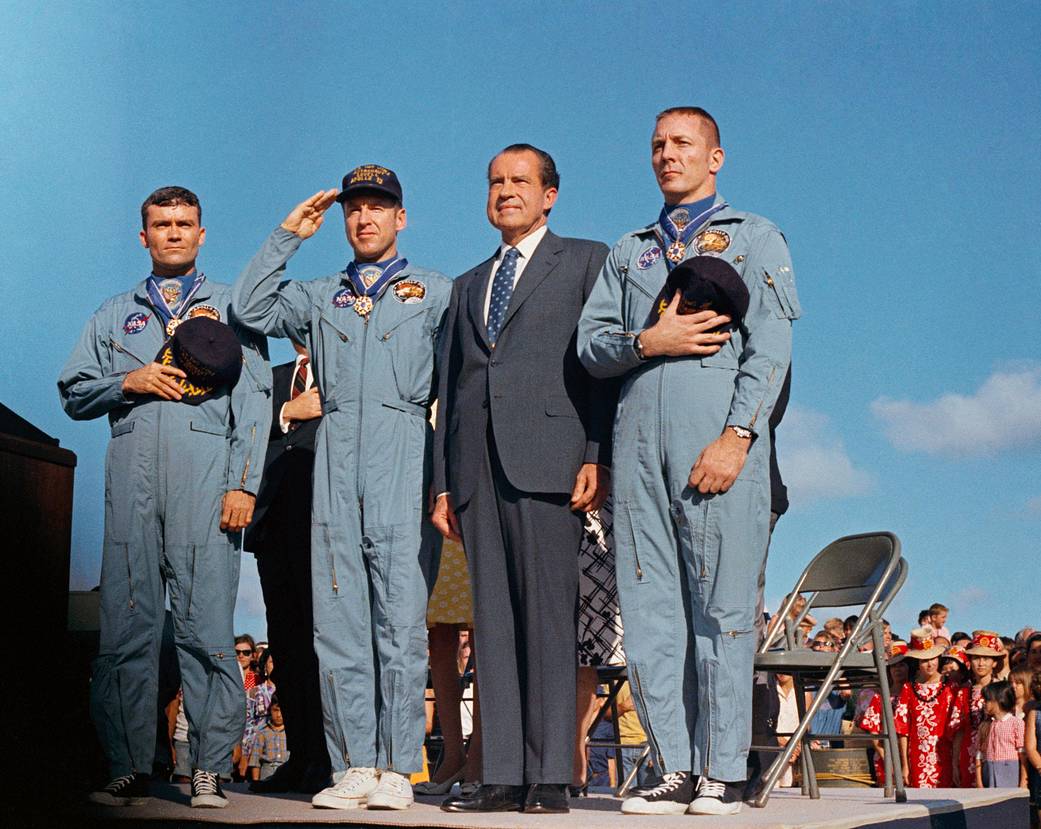 Apollo 13 crew and President Richard Nixon standing and saluting