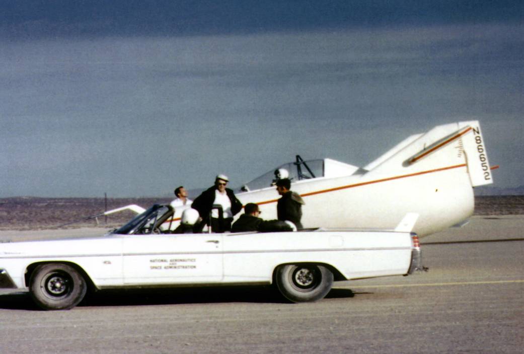 M2-F1 on lakebed with Pontiac convertible tow vehicle