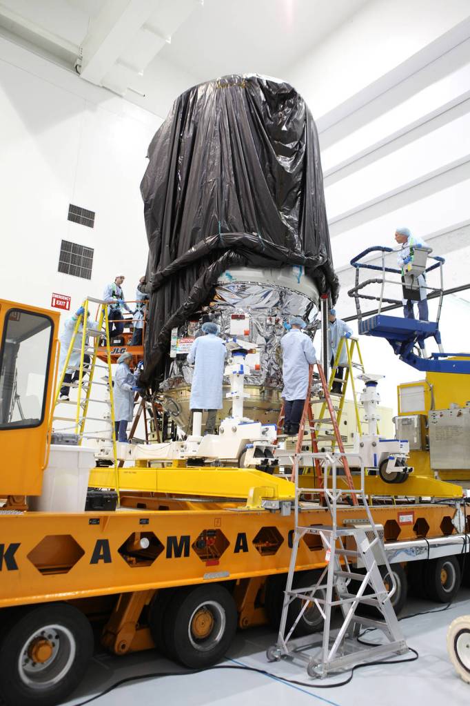Technicians Secure the Protective Covering Around Cygnus