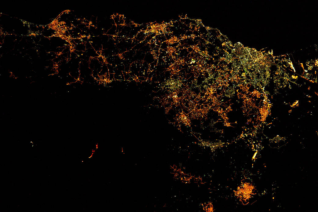Nighttime view from orbit of Sicily with red lines showing volcano eruption