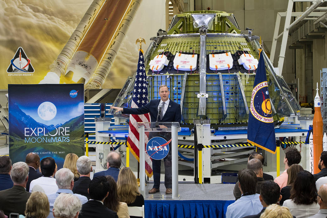 Administrator Bridenstine speaks at facility with spacecraft in background