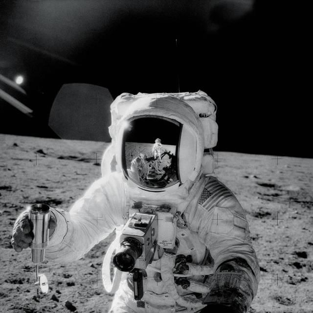 During an Apollo 12 extravehicular activity,  Commander Charles Conrad Jr. is reflected in the helmet visor of Alan L Bean..