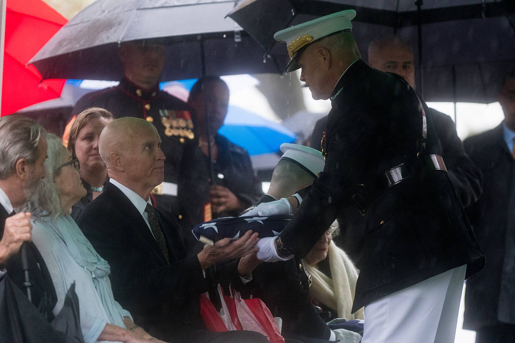 David Glenn son of John Glenn receives American flag during a graveside interment 