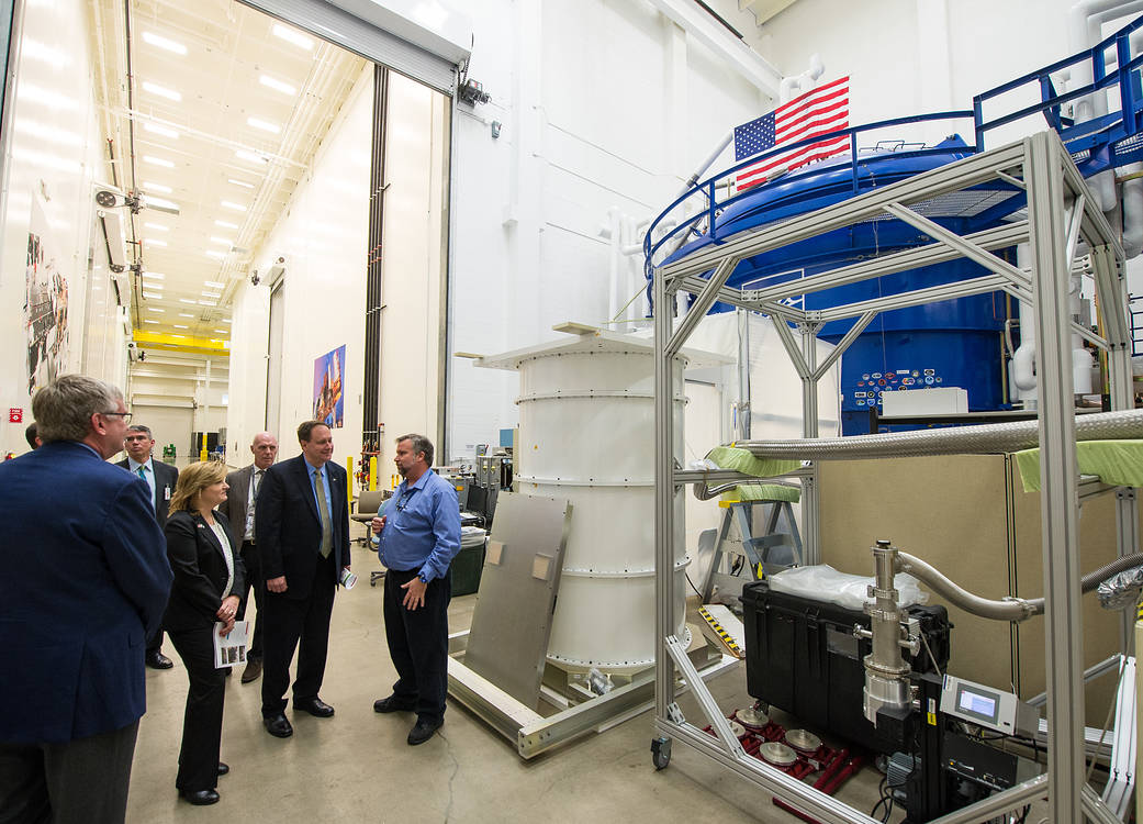 NASA officials and Ball Aerospace staff speak at vaccuum chamber facility