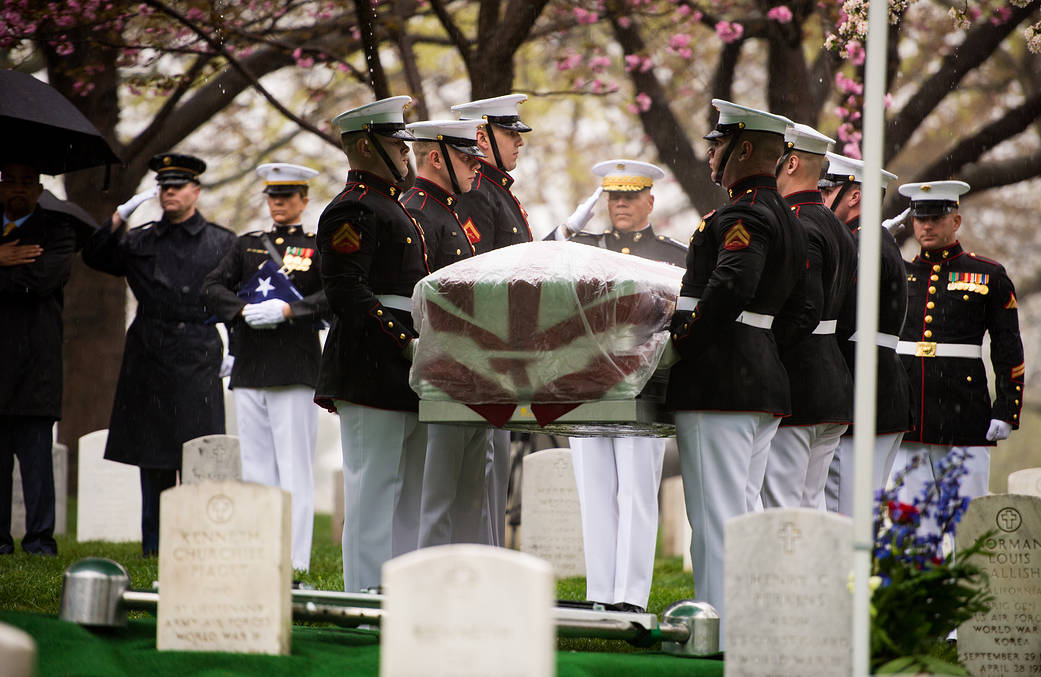 Pallbearers carry flag draped coffin of John Glenn