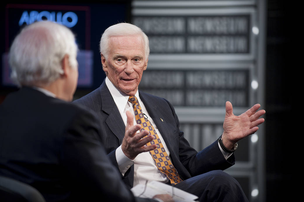 Gene Cernan, seated, answers questions from journalist at Newseum